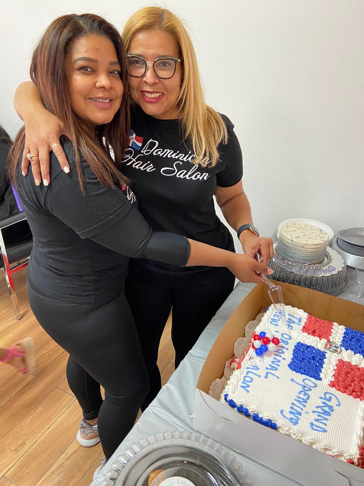 Dominican Hair Salon owners celebrating with a cake